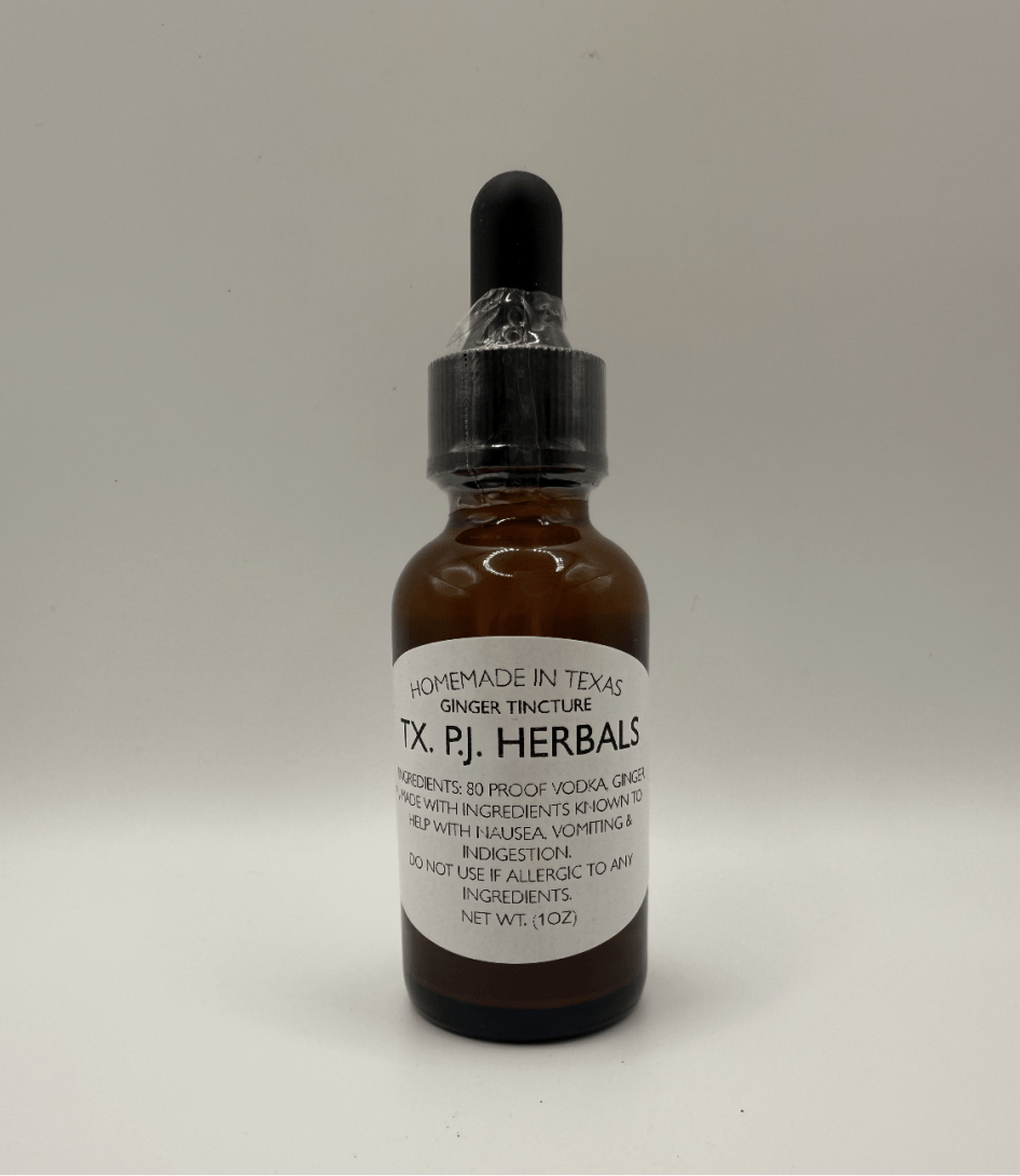 Amber glass bottle of homemade ginger tincture with black dropper cap by TX P.J. Herbals, natural inflammation and nausea relief.