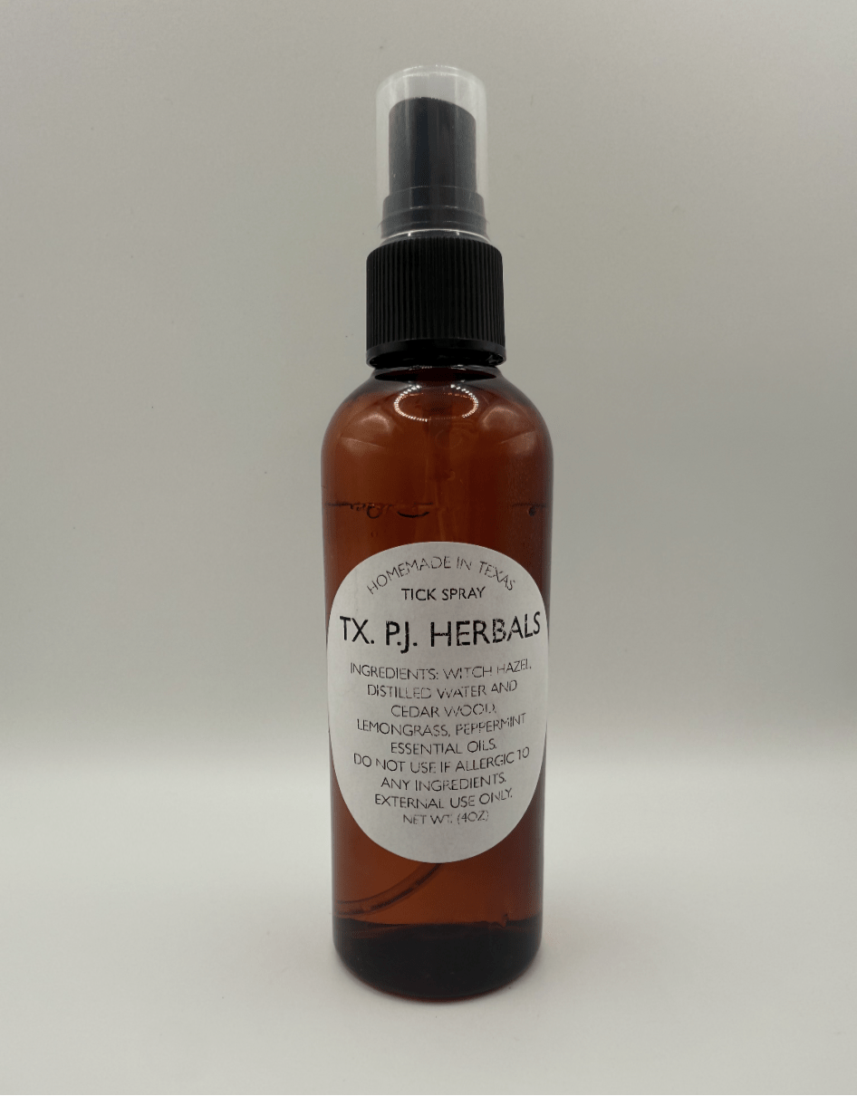 All-natural tick spray in amber 4 oz bottle with black spray top, made with witch hazel, essential oils, and cedar wood for safe tick repellent.