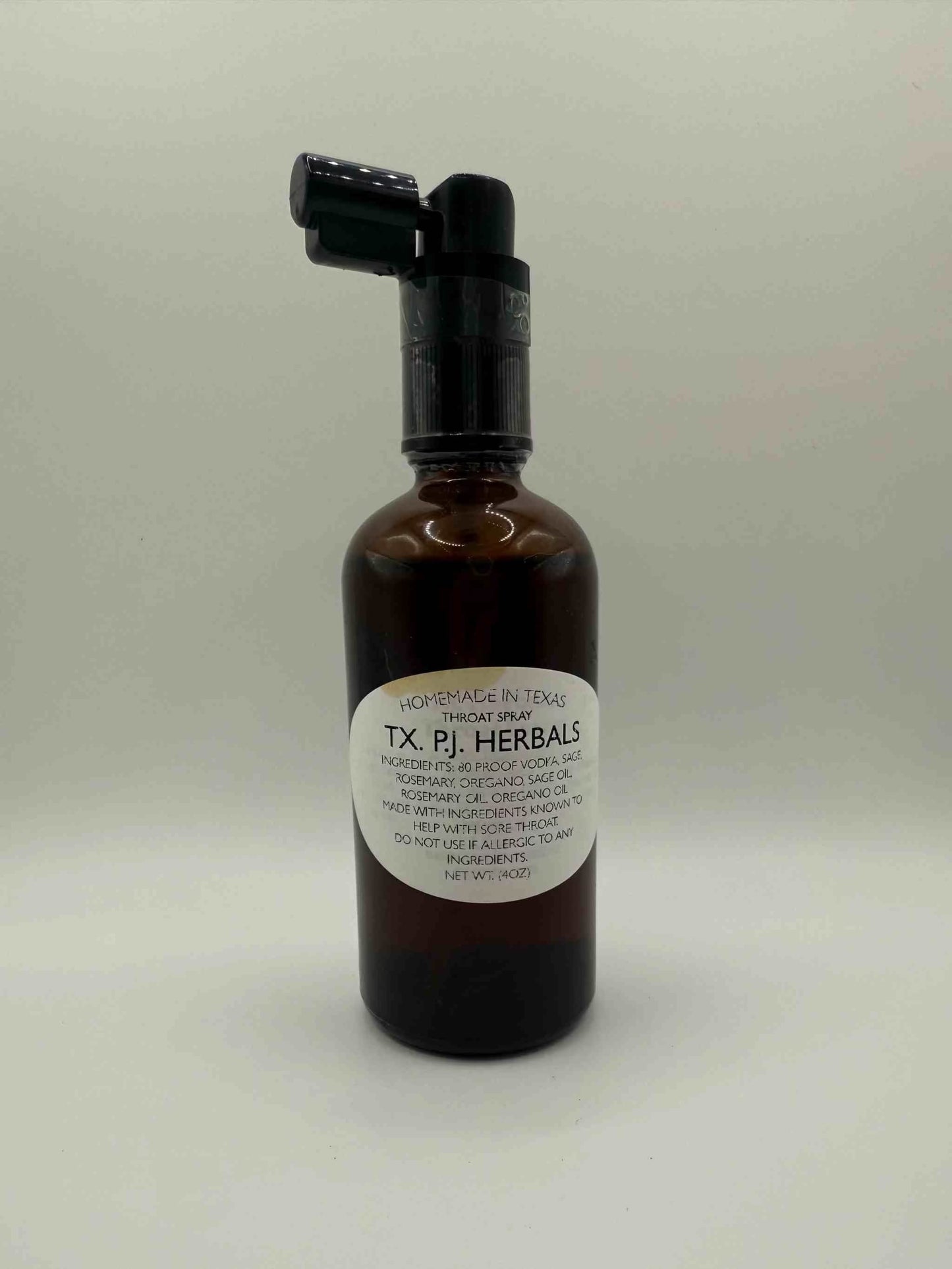 Herbal Throat Spray in brown bottle with black spray top for natural sore throat relief