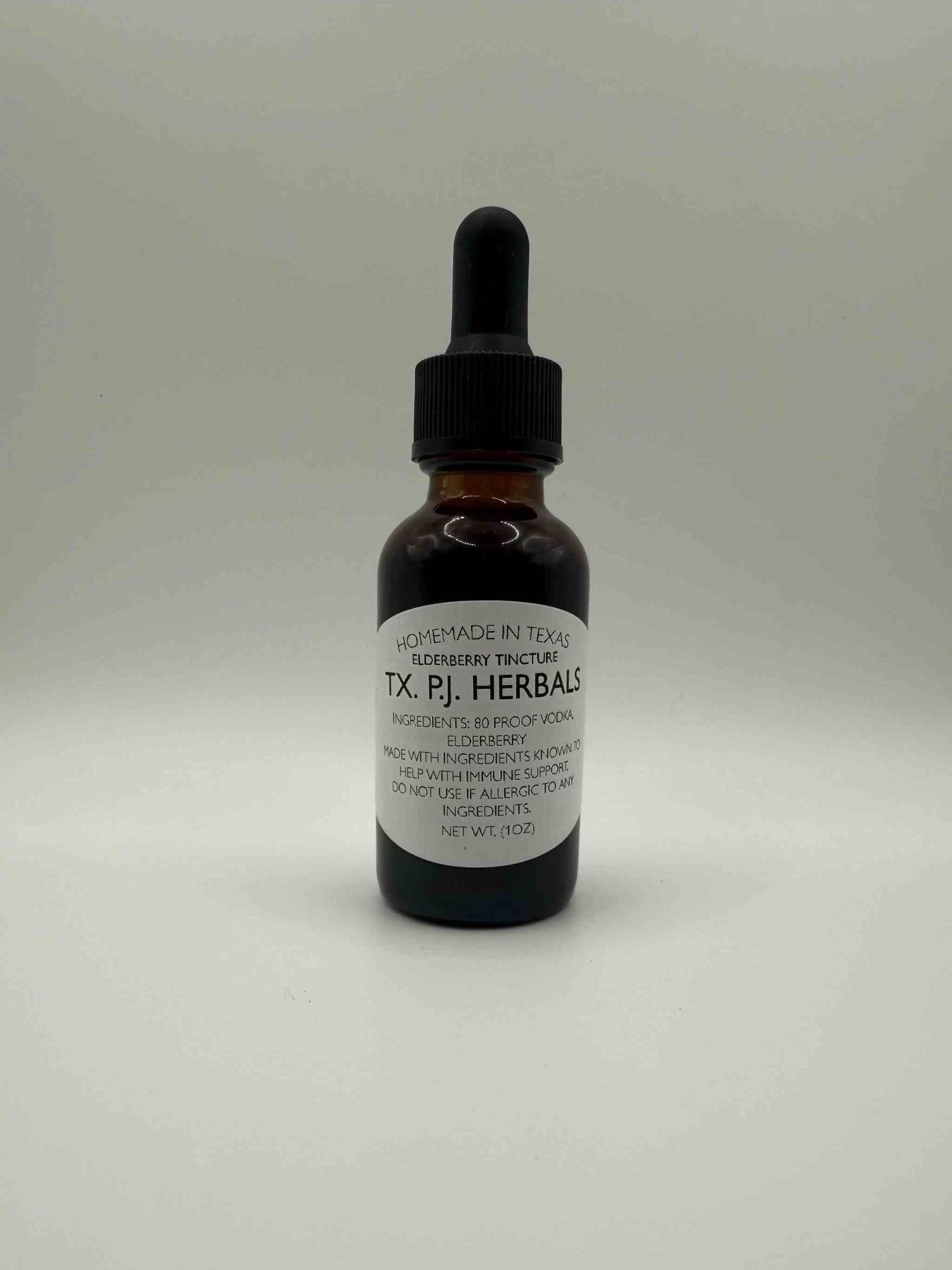 Brown glass bottle of Elderberry Tincture with dropper and white label showing herbal supplement details