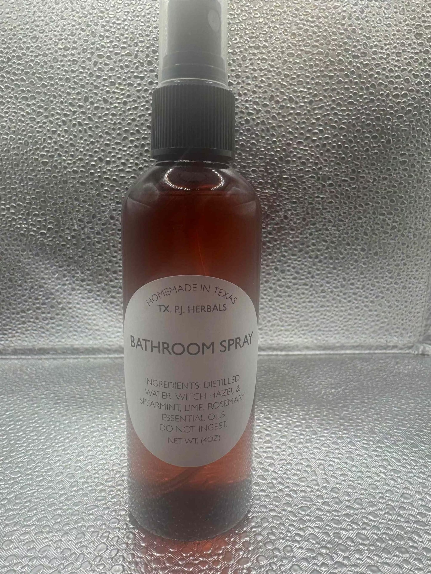 All-Natural Bathroom Spray in amber bottle with herbal ingredients for safe odor elimination and refreshing scent