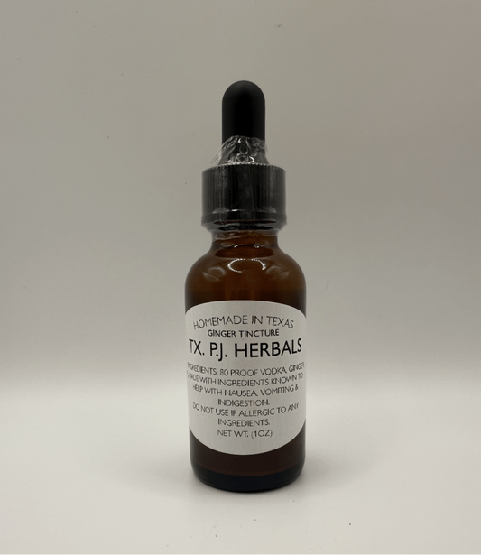 Amber glass bottle of homemade ginger tincture with black dropper cap by TX P.J. Herbals, natural inflammation and nausea relief.