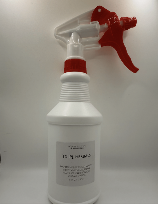 White spray bottle of non-toxic glass cleaner with red trigger and label showing natural ingredients for streak-free shine