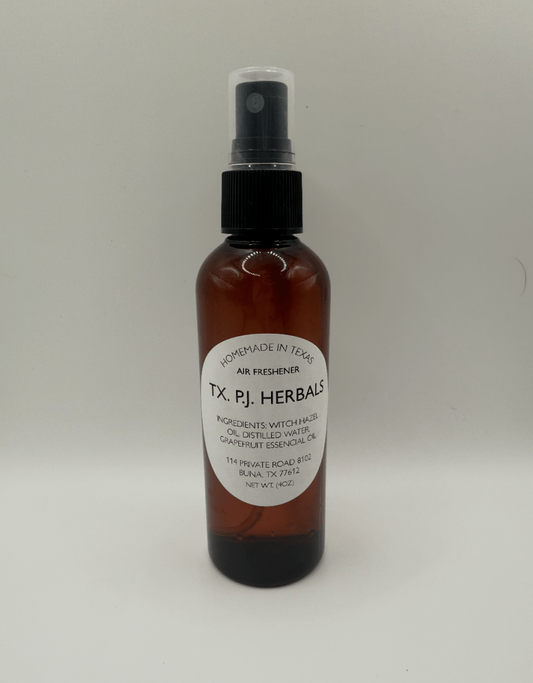Brown spray bottle of all-natural air freshener with label showing ingredients witch hazel and grapefruit essential oil safe for families and pets